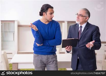 The male real estate agent and male client in the apartment . Male real estate agent and male client in the apartment