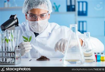 The male scientist researcher doing experiment in a laboratory. Male scientist researcher doing experiment in a laboratory