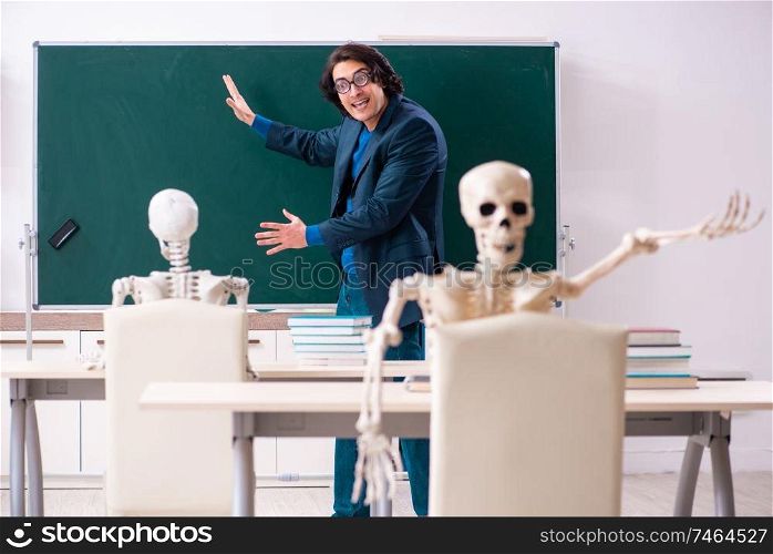 The male teacher and skeleton student in the classroom . Male teacher and skeleton student in the classroom 