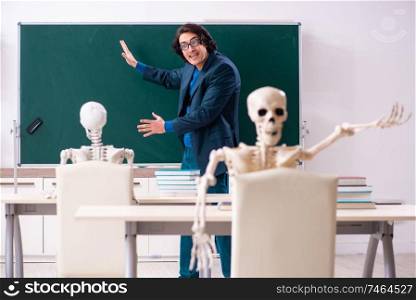 The male teacher and skeleton student in the classroom . Male teacher and skeleton student in the classroom 