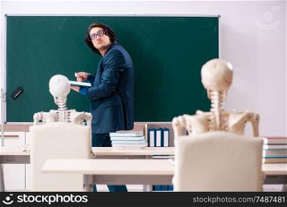 The male teacher and skeleton student in the classroom. Male teacher and skeleton student in the classroom