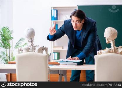 The male teacher and skeleton student in the classroom. Male teacher and skeleton student in the classroom