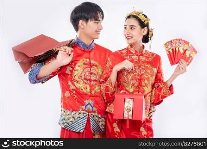 The Man and woman get the red bag , gift money and some gift from their relative in wedding day