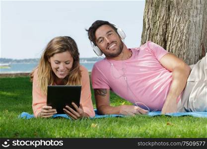 the man and woman lay on the grass