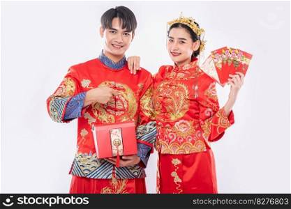 The Man and woman wear Cheongsam proud to get - give the gift money and red bag for traditional day