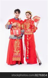 The Man and woman wear Cheongsam proud to get - give the gift money and red bag for traditional day