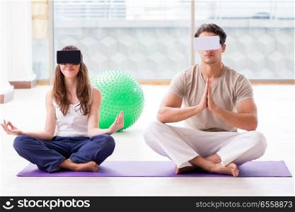 The man and woman with vr glasses meditating. Man and woman with VR glasses meditating