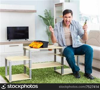 The man assembling furniture at home. Man assembling furniture at home