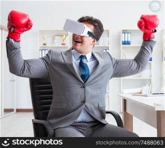 The man boxing in the office with virtual reality goggles. Man boxing in the office with virtual reality goggles