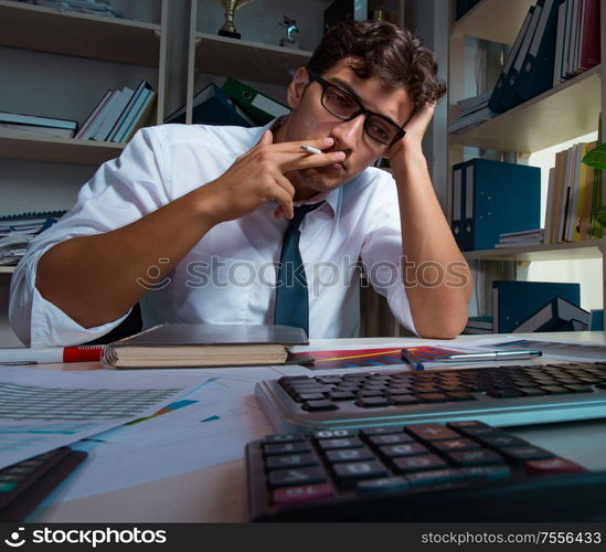 The man businessman working late hours in the office. Man businessman working late hours in the office