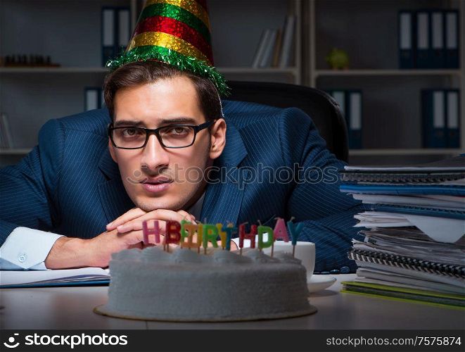 The man celebrating birthday in the office. Man celebrating birthday in the office