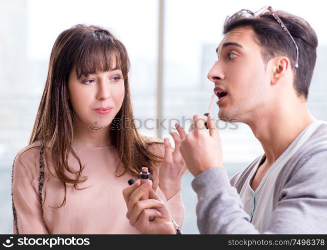 The man doing make-up for cute woman in beauty salon. Man doing make-up for cute woman in beauty salon