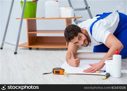 The man doing wallpaper refurbishment at home. Man doing wallpaper refurbishment at home