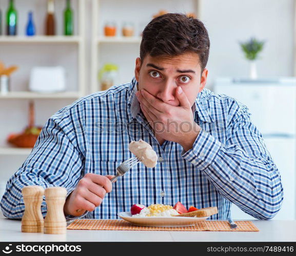 The man eating tasteless food at home for lunch. Man eating tasteless food at home for lunch