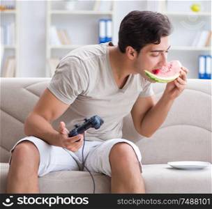 The man eating watermelon at home. Man eating watermelon at home