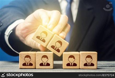 The man expands the team and adds new members. Company organization. Hiring workers. Leadership skills, team personnel management. Recruiting fresh employees for a large project. Accession cooperation