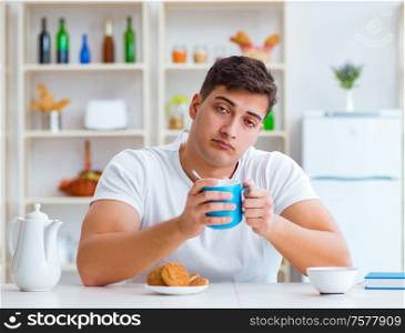 The man falling asleep during his breakfast after overtime work. Man falling asleep during his breakfast after overtime work