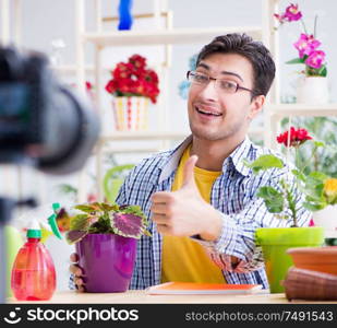 The man florist gardener vlogger blogger shooting video on camera. Man florist gardener vlogger blogger shooting video on camera