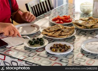 The man having breakfast at the village breakfast table. Varieties of breakfast in Turkey