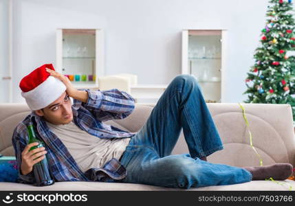 The man having hangover after christmas party. Man having hangover after christmas party