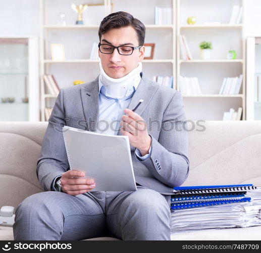 The man in neck brace cervical collar working from home teleworking. Man in neck brace cervical collar working from home teleworking