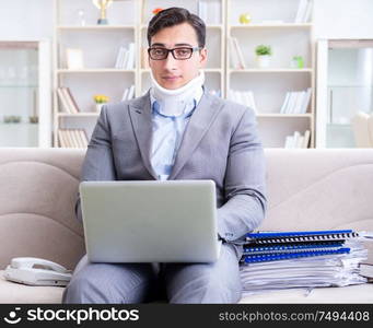 The man in neck brace cervical collar working from home teleworking. Man in neck brace cervical collar working from home teleworking