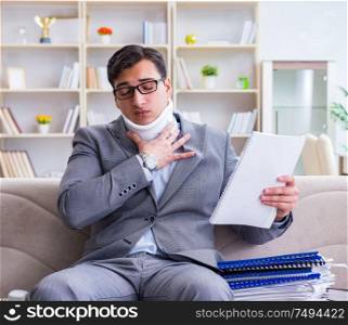 The man in neck brace cervical collar working from home teleworking. Man in neck brace cervical collar working from home teleworking