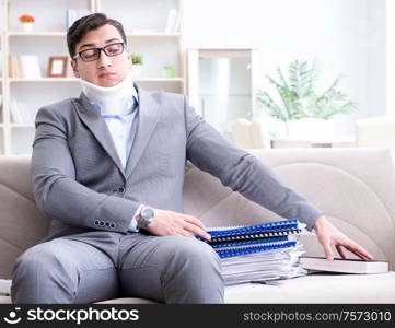 The man in neck brace cervical collar working from home teleworking. Man in neck brace cervical collar working from home teleworking