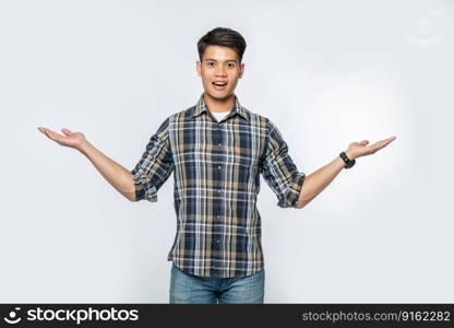 The man in the black shirt and the hand sign opened to both sides.