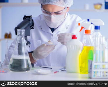 The man in the lab testing new cleaning solution detergent. Man in the lab testing new cleaning solution detergent