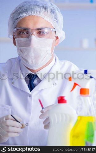 The man in the lab testing new cleaning solution detergent. Man in the lab testing new cleaning solution detergent