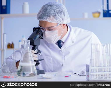 The man in the lab testing new cleaning solution detergent. Man in the lab testing new cleaning solution detergent