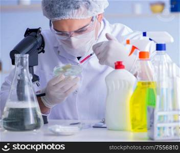 The man in the lab testing new cleaning solution detergent. Man in the lab testing new cleaning solution detergent