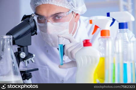 The man in the lab testing new cleaning solution detergent. Man in the lab testing new cleaning solution detergent