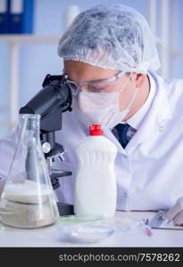 The man in the lab testing new cleaning solution detergent. Man in the lab testing new cleaning solution detergent