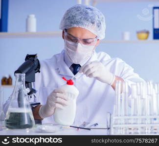 The man in the lab testing new cleaning solution detergent. Man in the lab testing new cleaning solution detergent