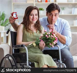 The man making marriage proposal to disabled woman on wheelchair. Man making marriage proposal to disabled woman on wheelchair