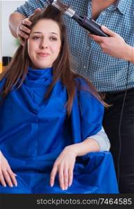 The man male hairdresser doing haircut for woman. Man male hairdresser doing haircut for woman