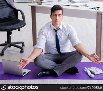The man meditating in the office to cope with stress. Man meditating in the office to cope with stress