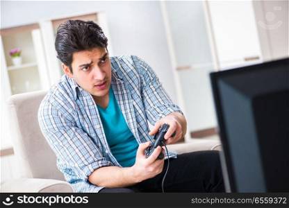 The man playing computer game at home. Man playing computer game at home