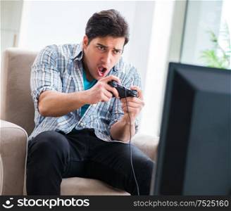 The man playing computer game at home. Man playing computer game at home