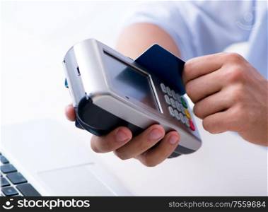 The man processing credit card transaction with pos terminal. Man processing credit card transaction with POS terminal