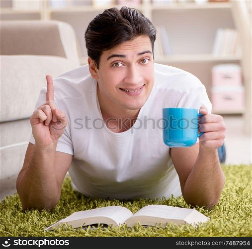 The man reading book at home on floor. Man reading book at home on floor