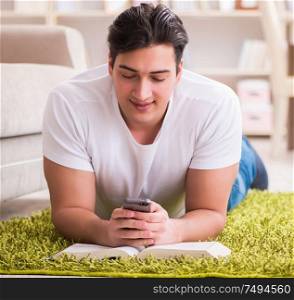 The man reading book at home on floor. Man reading book at home on floor