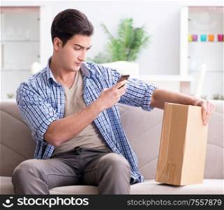 The man receiving parcel at home. Man receiving parcel at home