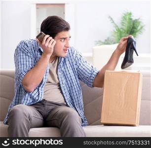 The man receiving wrong parcel with female woman shoes. Man receiving wrong parcel with female woman shoes