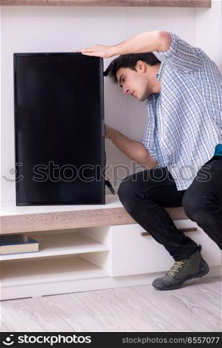 The man repairing broken tv at home. Man repairing broken tv at home