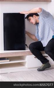 The man repairing broken tv at home. Man repairing broken tv at home