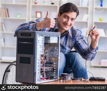 The man repairing pc with thumbs up. Man repairing pc with thumbs up