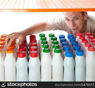 The man selects dairy products in the shop